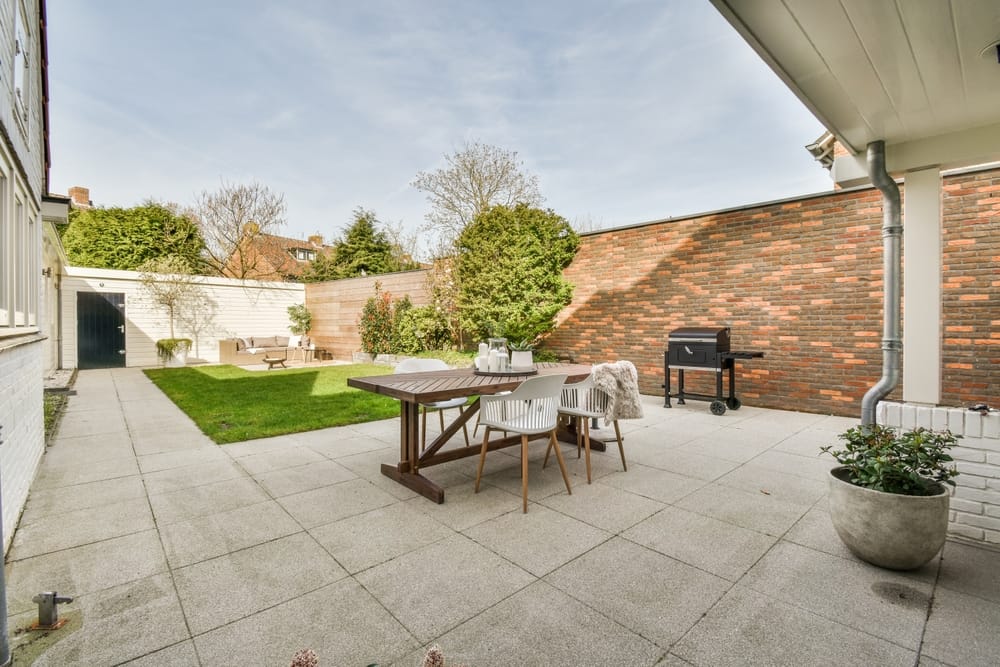 Neat,Paved,Patio,With,Sitting,Area,And,Small,Garden,Near